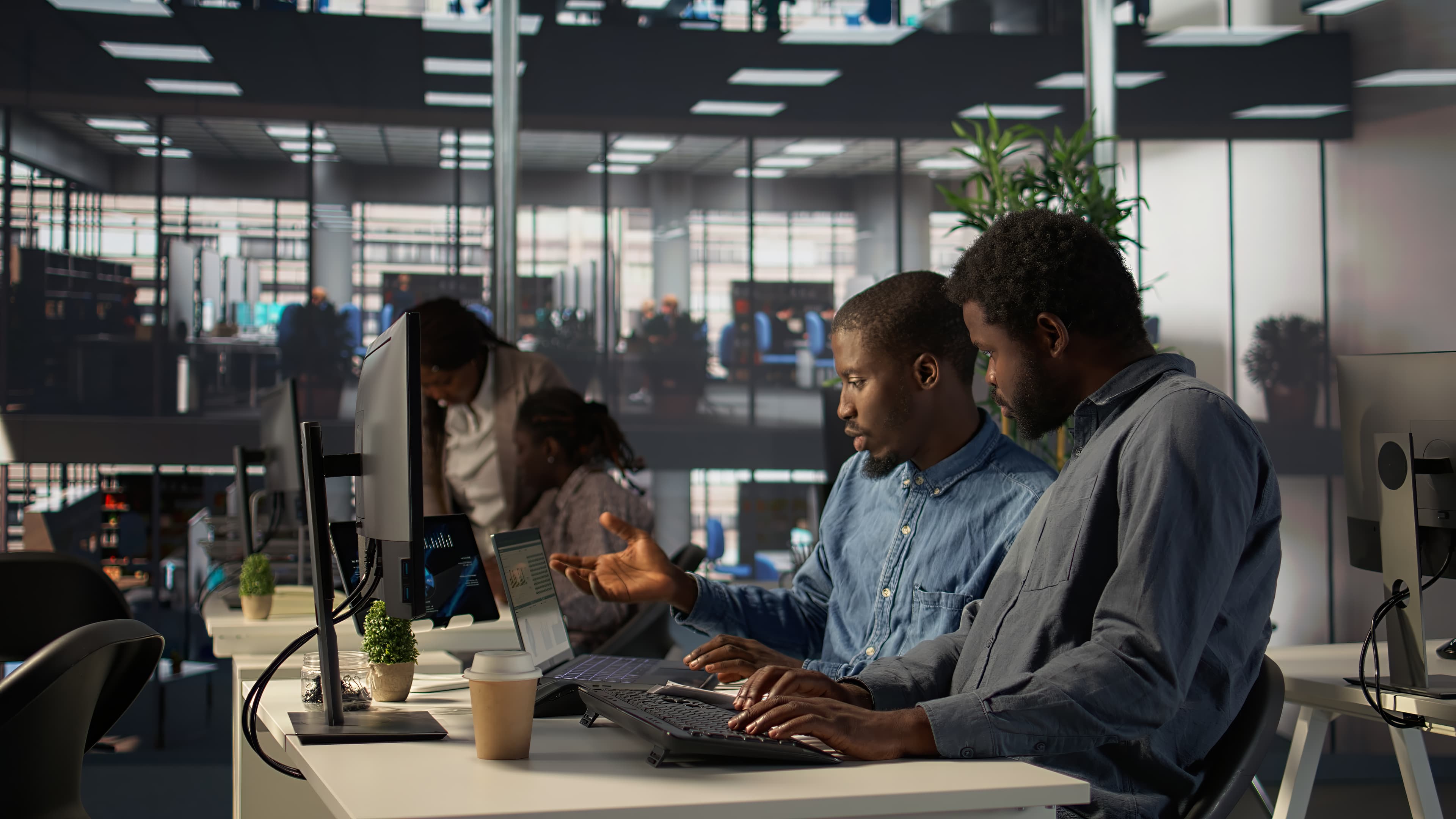 Design and product team collaborating around laptops